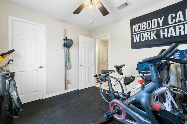 workout room featuring visible vents, a ceiling fan, and baseboards