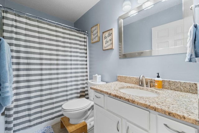 full bathroom with tile patterned flooring, a textured ceiling, toilet, and vanity