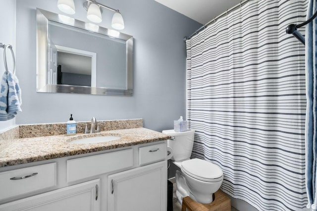 bathroom featuring toilet and vanity