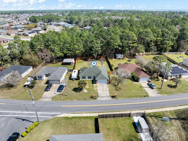 birds eye view of property featuring a residential view and a view of trees