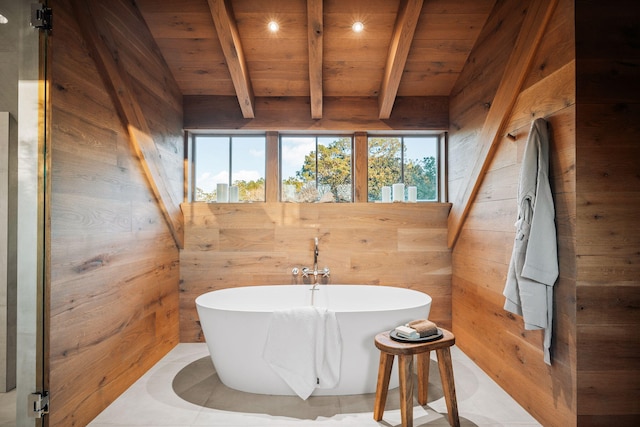 full bath featuring wooden walls, wood ceiling, beam ceiling, and a soaking tub