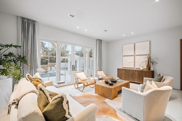 living area with visible vents and recessed lighting