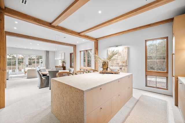 kitchen featuring hanging light fixtures, modern cabinets, light countertops, beamed ceiling, and recessed lighting
