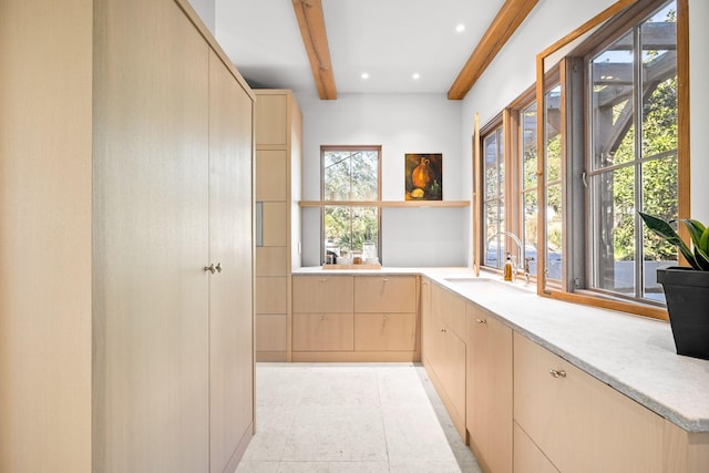 bar featuring a wealth of natural light, recessed lighting, a sink, and beam ceiling