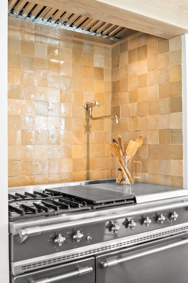 interior details with stainless steel stove and backsplash