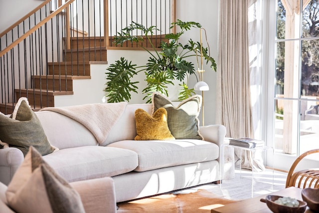 living area with stairs and a healthy amount of sunlight