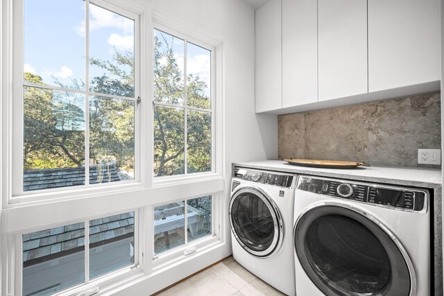 laundry area featuring independent washer and dryer and cabinet space