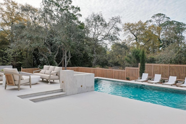 view of swimming pool featuring a patio, a fenced backyard, and a fenced in pool