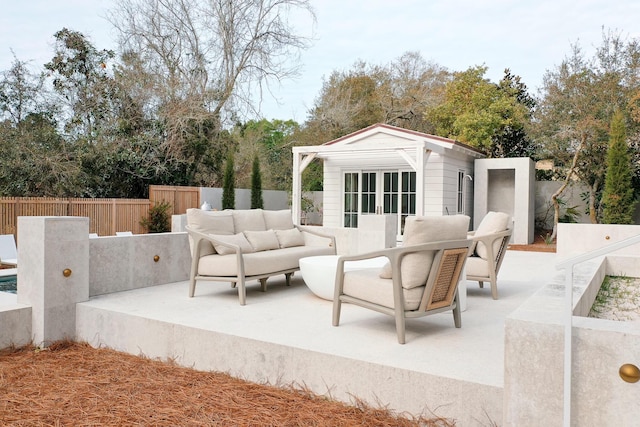 view of patio / terrace with a fenced backyard, an outdoor structure, an outdoor hangout area, and an exterior structure