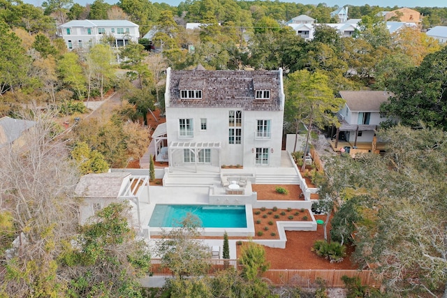 back of property with a patio area, fence, stairway, stucco siding, and an outdoor pool