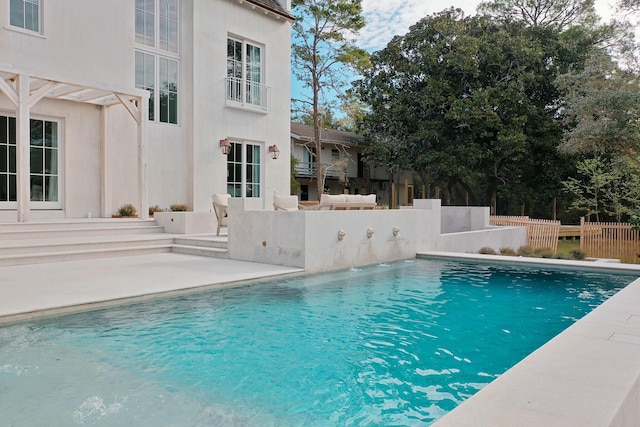 view of swimming pool with a patio area, a fenced in pool, and fence