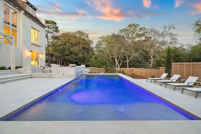 view of swimming pool featuring a patio, a fenced backyard, and a fenced in pool