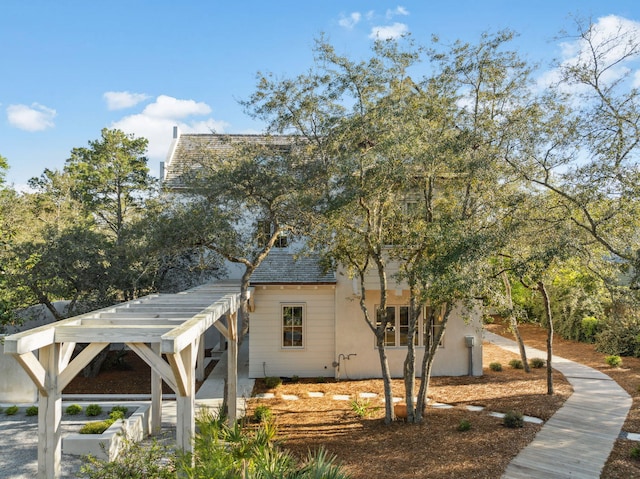 view of home's exterior with a pergola