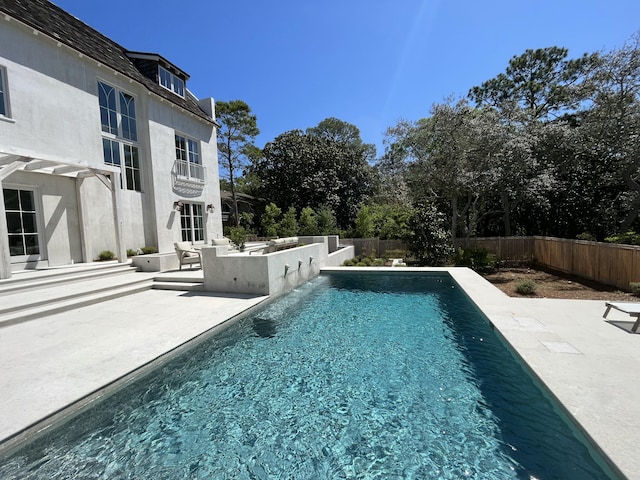 view of swimming pool featuring a fenced in pool, a patio, and a fenced backyard