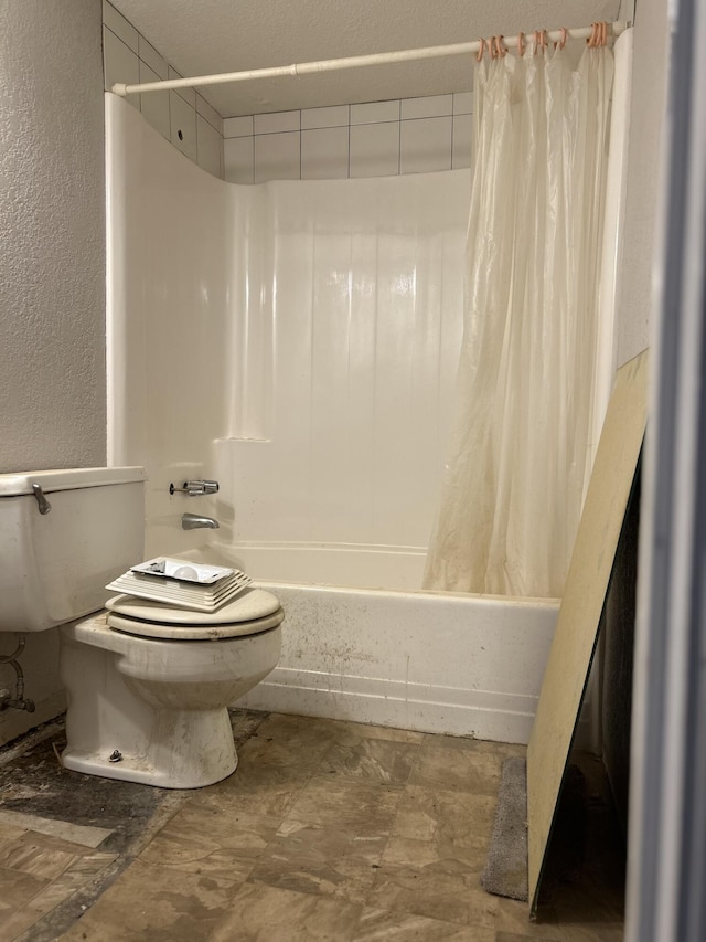 bathroom featuring shower / bath combination with curtain, a textured wall, and toilet