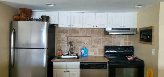 kitchen featuring under cabinet range hood, a sink, white cabinetry, backsplash, and black appliances