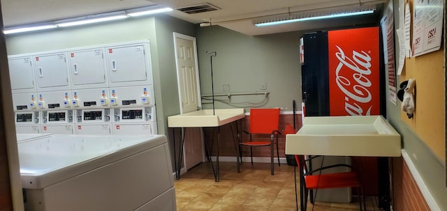 common laundry area featuring stacked washer and dryer and visible vents