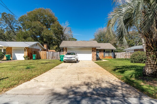 ranch-style home with fence, a front lawn, concrete driveway, a garage, and brick siding