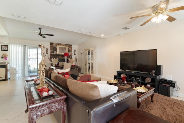 living room with tile patterned floors, visible vents, and vaulted ceiling