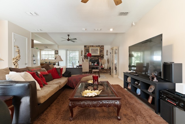 living room featuring visible vents, a ceiling fan, and vaulted ceiling