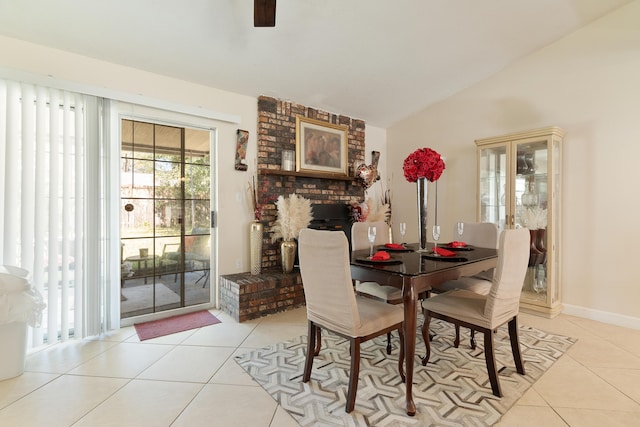 dining space with light tile patterned floors, baseboards, and vaulted ceiling