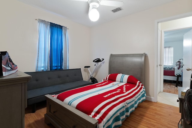 bedroom featuring visible vents, ceiling fan, and light wood-style floors