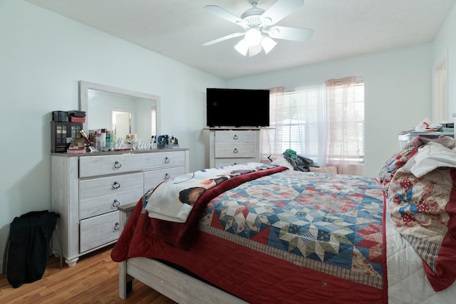 bedroom with a ceiling fan and light wood finished floors