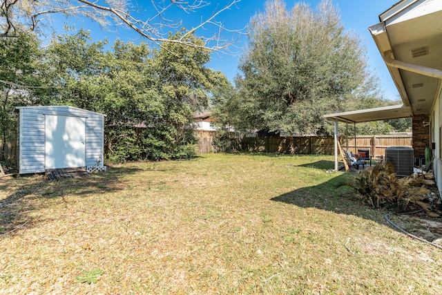 view of yard with a fenced backyard, cooling unit, a storage unit, and an outdoor structure