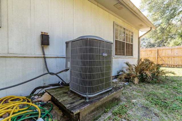 exterior details with central air condition unit and fence