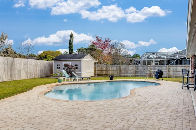 view of pool featuring a fenced in pool, a patio area, a fenced backyard, and an outdoor structure