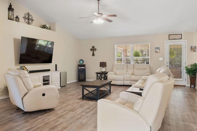 living room featuring light wood-style floors, ceiling fan, high vaulted ceiling, and baseboards