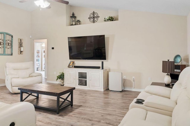 living room with baseboards, ceiling fan, high vaulted ceiling, and wood finished floors