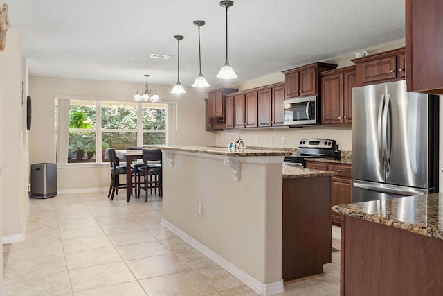 kitchen featuring appliances with stainless steel finishes, stone countertops, visible vents, and light tile patterned floors