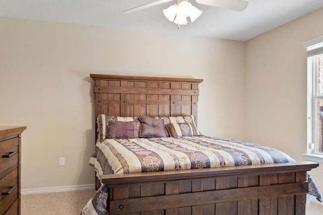 bedroom featuring ceiling fan, baseboards, and carpet flooring