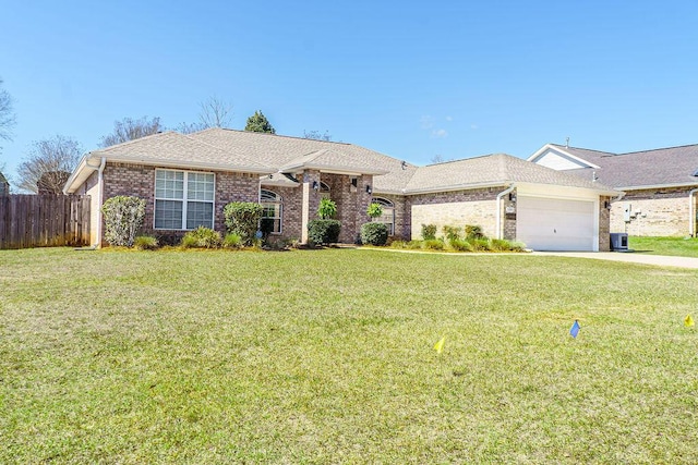 ranch-style house featuring an attached garage, brick siding, fence, and a front lawn