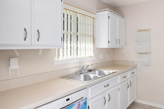 kitchen featuring light countertops, light tile patterned flooring, a sink, and white cabinets