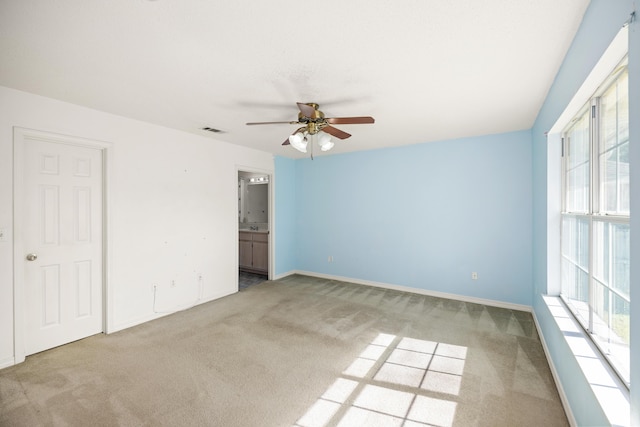 interior space with baseboards, carpet, visible vents, and a ceiling fan