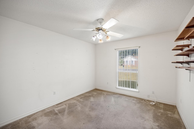 spare room featuring a ceiling fan, carpet flooring, a textured ceiling, and baseboards