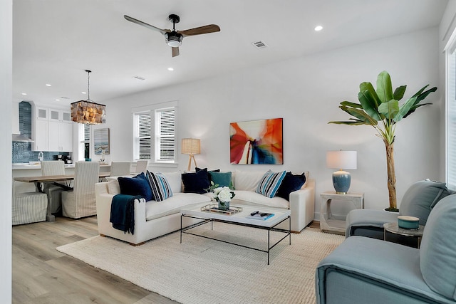 living area featuring light wood-style floors, recessed lighting, visible vents, and ceiling fan