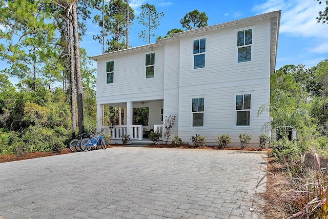 rear view of house featuring covered porch