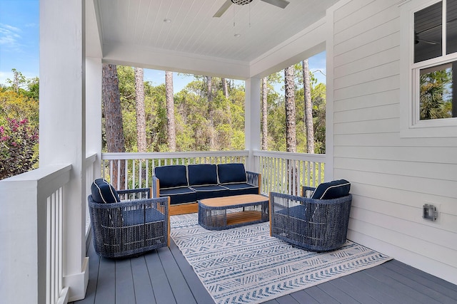 deck featuring ceiling fan and an outdoor living space