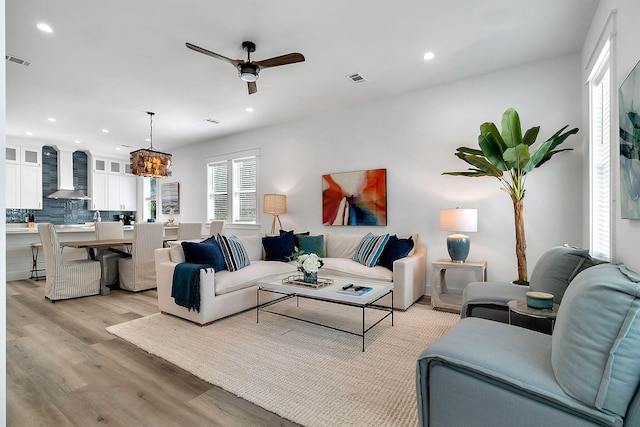 living area with ceiling fan, light wood-type flooring, visible vents, and recessed lighting