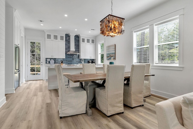 dining area with recessed lighting, visible vents, baseboards, light wood finished floors, and an inviting chandelier