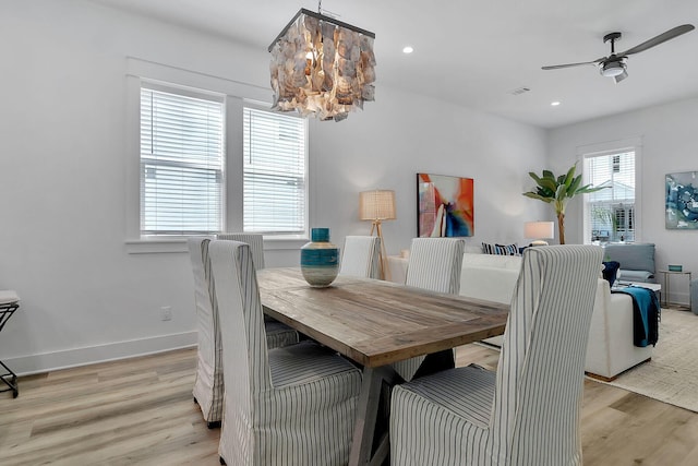 dining area featuring recessed lighting, ceiling fan with notable chandelier, visible vents, baseboards, and light wood-type flooring