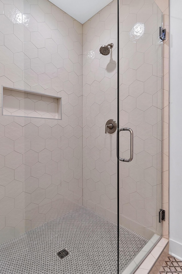 full bath with a shower stall