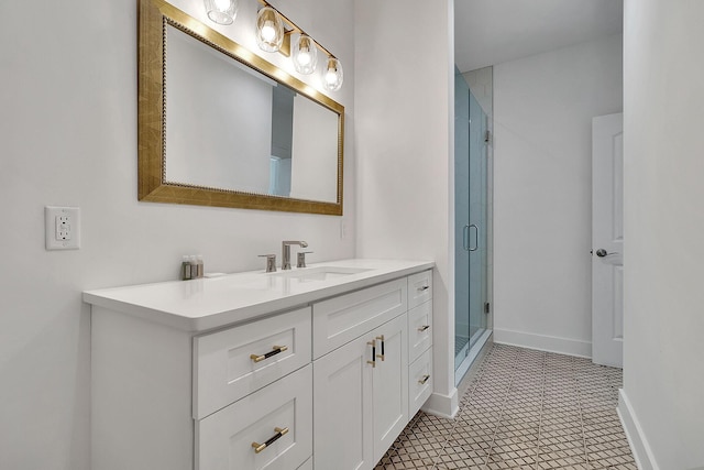 bathroom featuring a stall shower, vanity, and baseboards