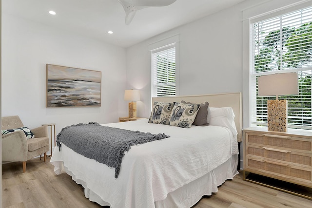 bedroom with wood finished floors, a ceiling fan, and recessed lighting