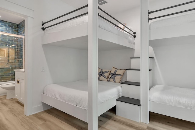 bedroom featuring baseboards and wood finished floors