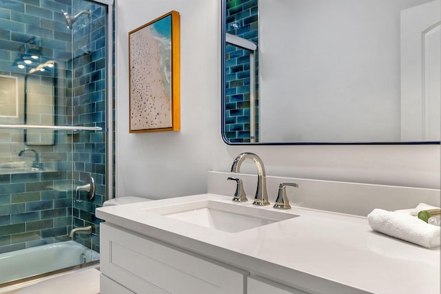 bathroom featuring enclosed tub / shower combo and vanity