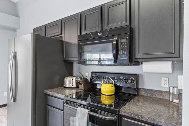 kitchen featuring dark countertops and black appliances